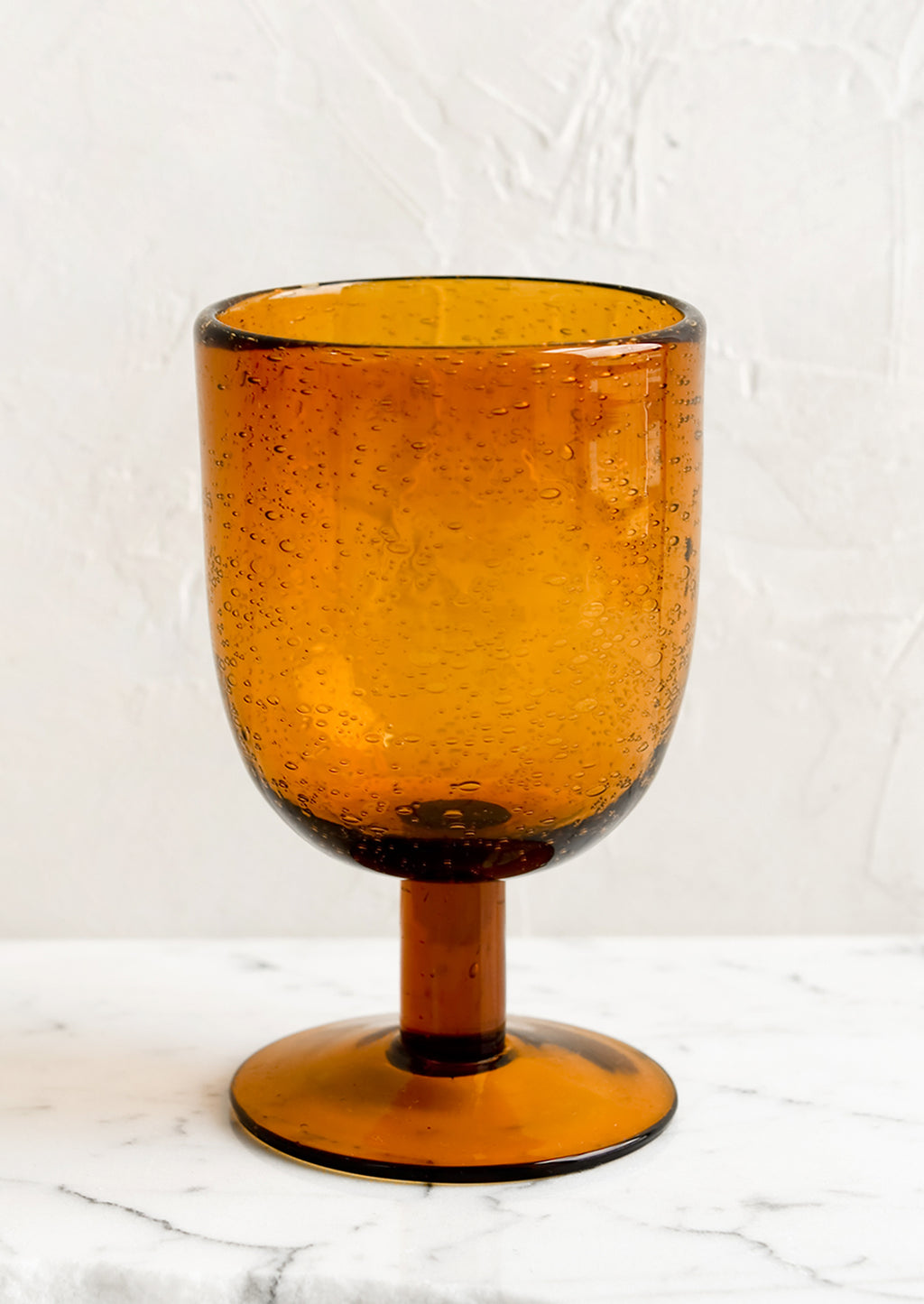 Short / Amber: A short stemware glass in amber color.