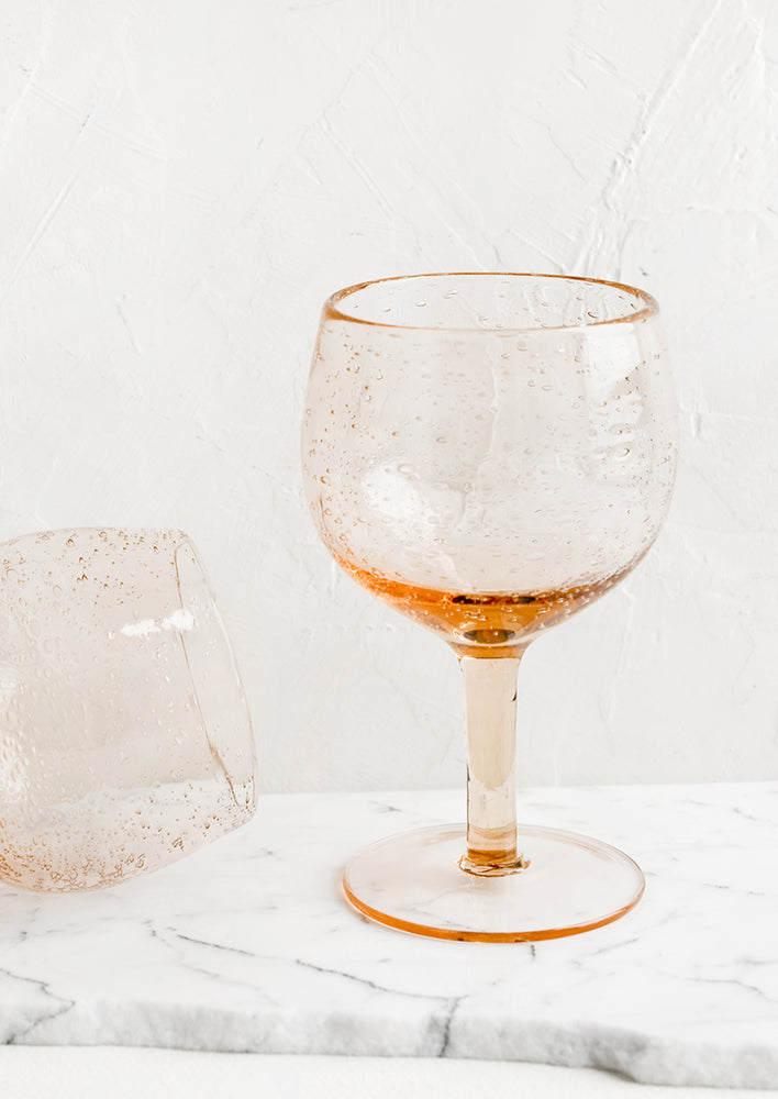 Tall / Rose: A tall wine glass in rose seeded glass.