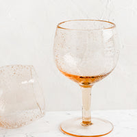Tall / Rose: A tall wine glass in rose seeded glass.