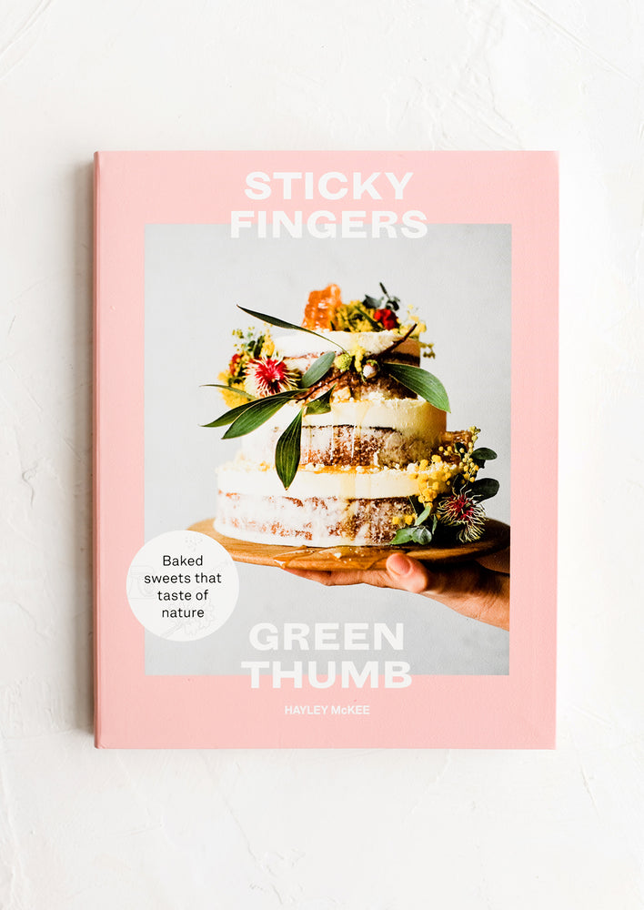 A cookbook with image of cake on cover.