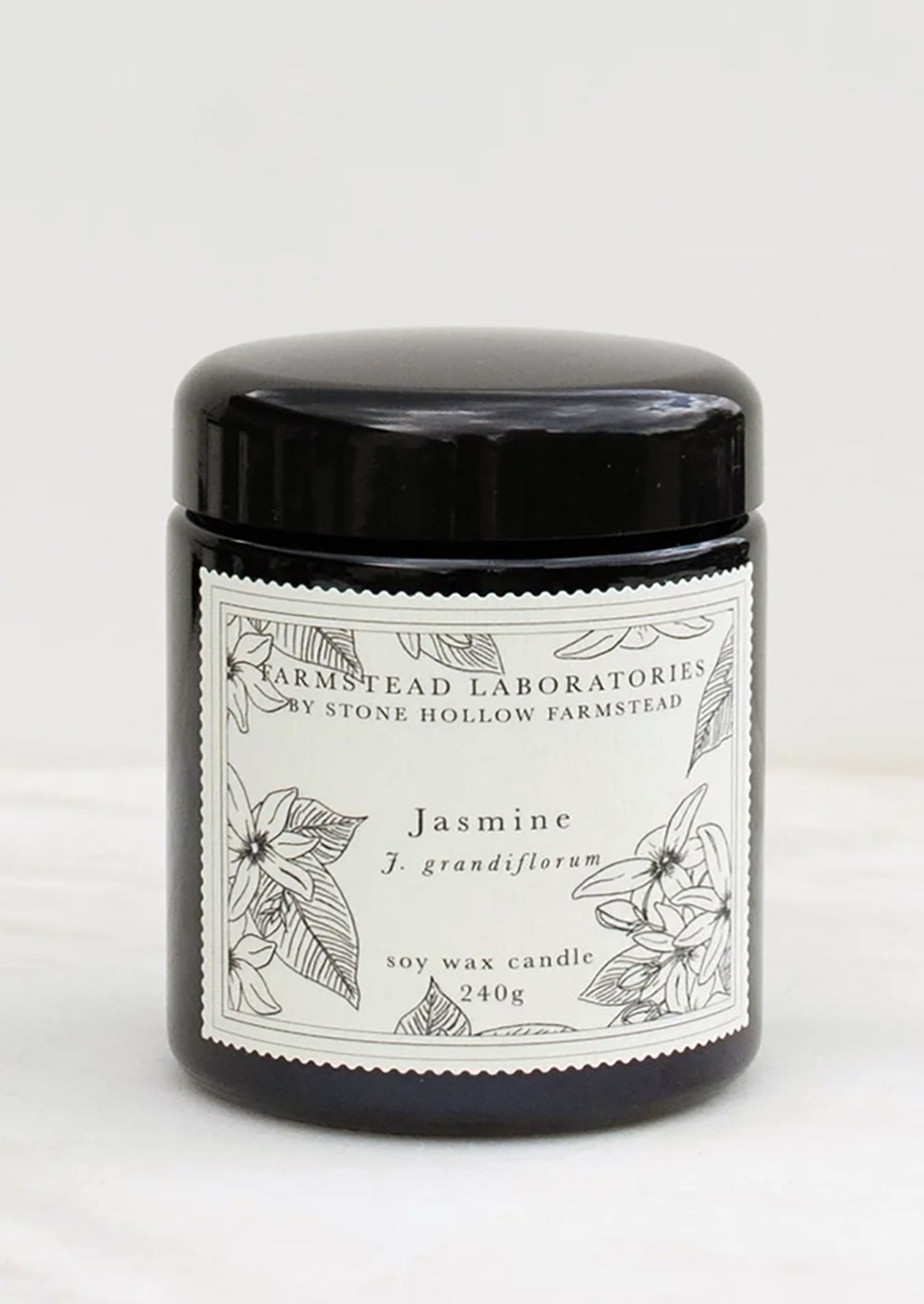 Jasmine: A jasmine scented candle in black jar with black and white botanical label.