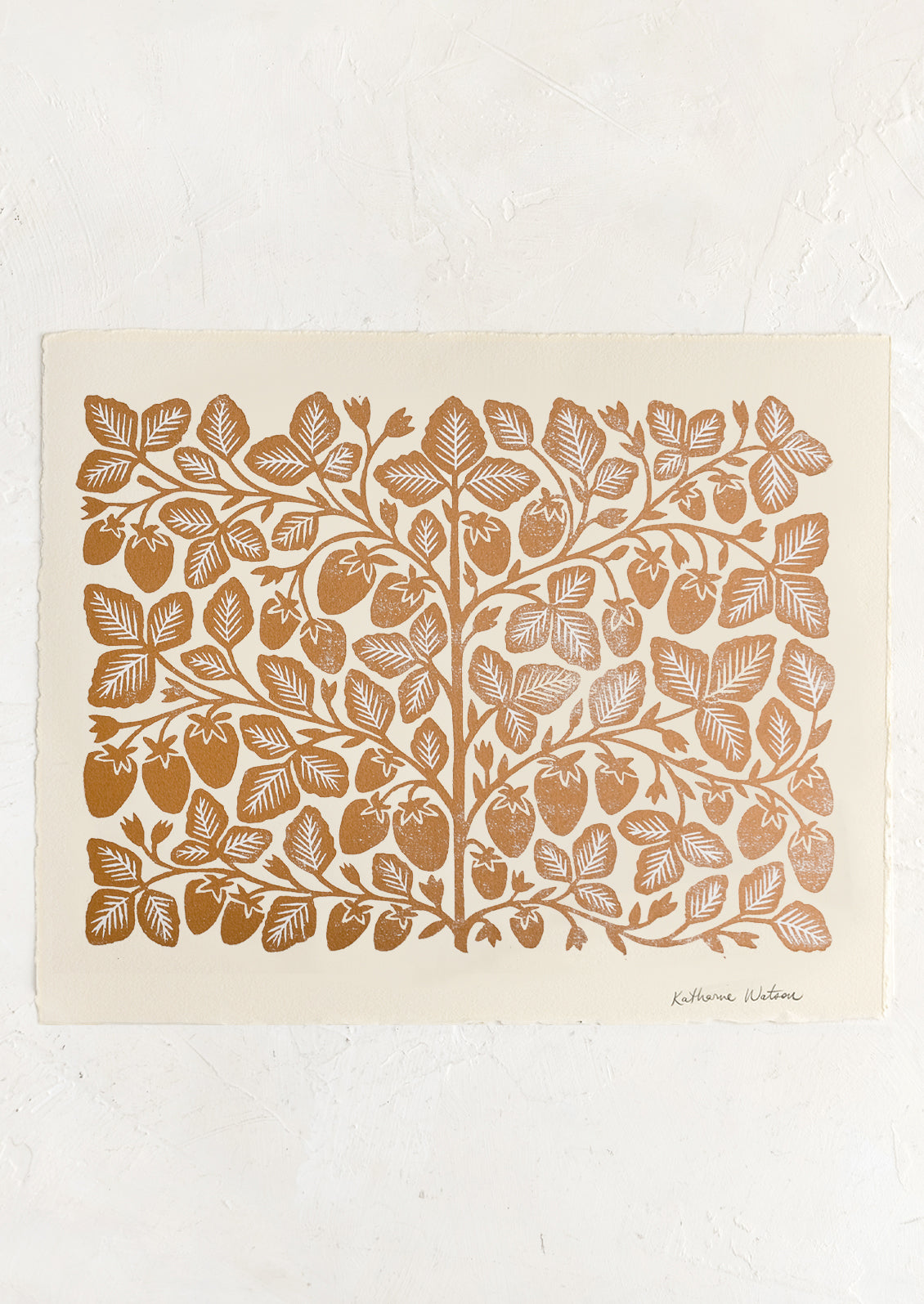 An ivory deckled edge paper with woodcut strawberry print in gold ink.