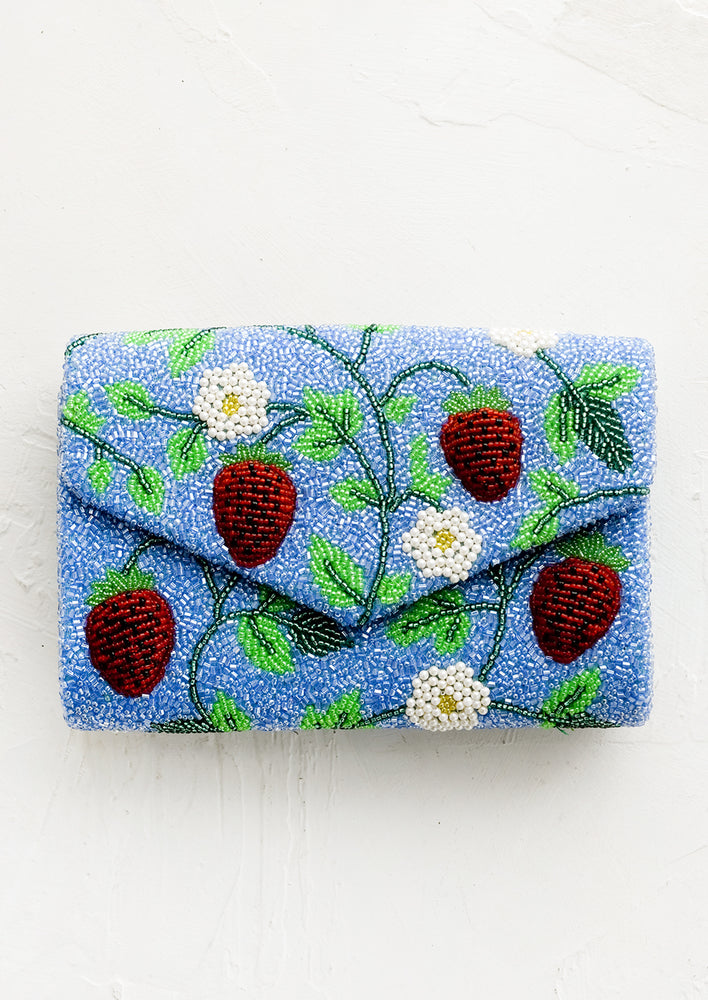 1: A blue beaded clutch with red strawberry pattern.