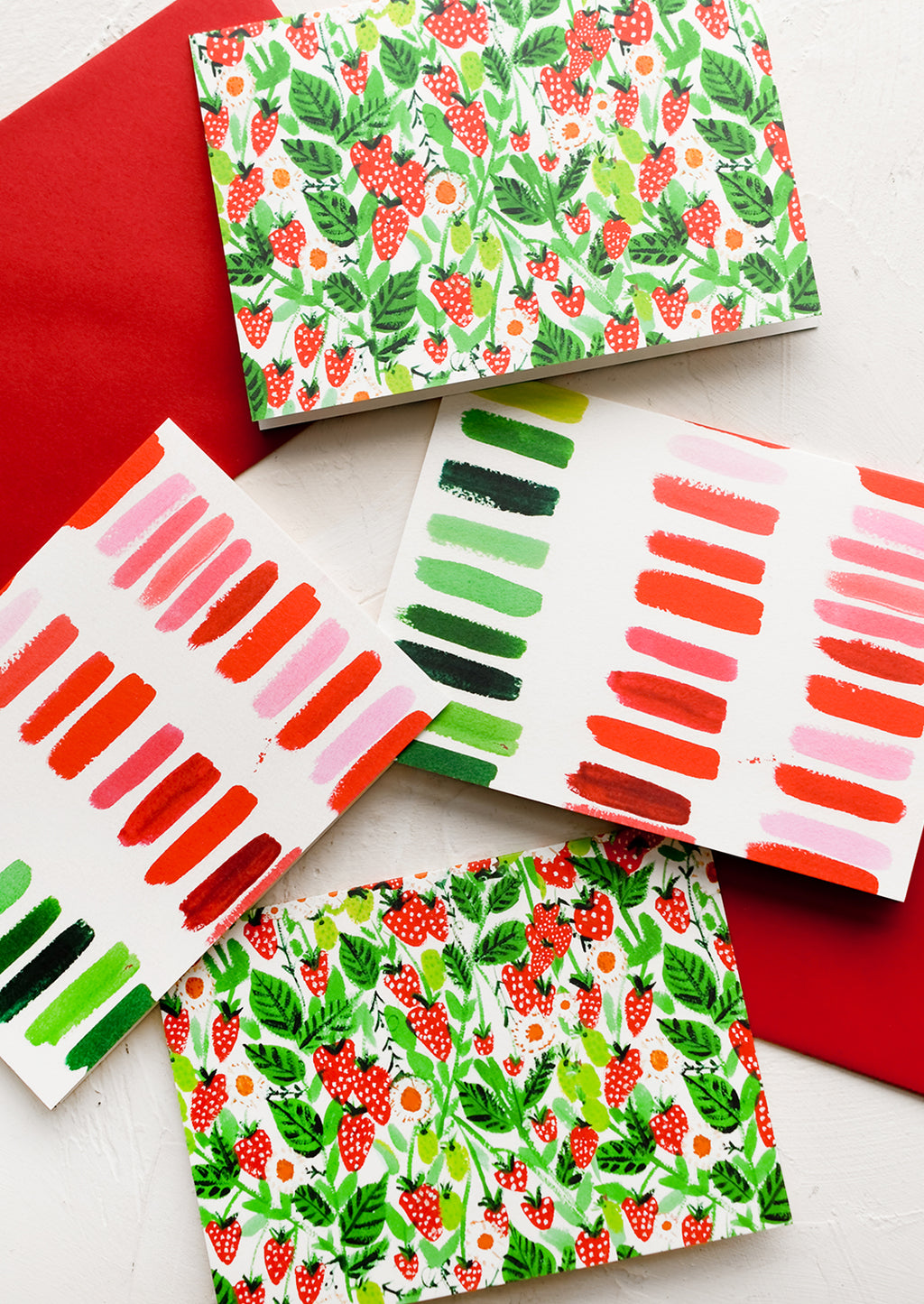 1: A set of cards with strawberry and brushstroke prints.