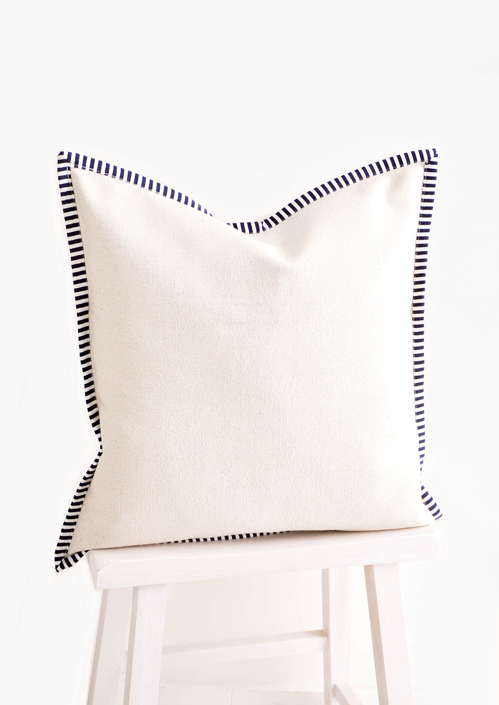 1: Square throw pillow in natural cotton canvas with striped navy & white trim around edges