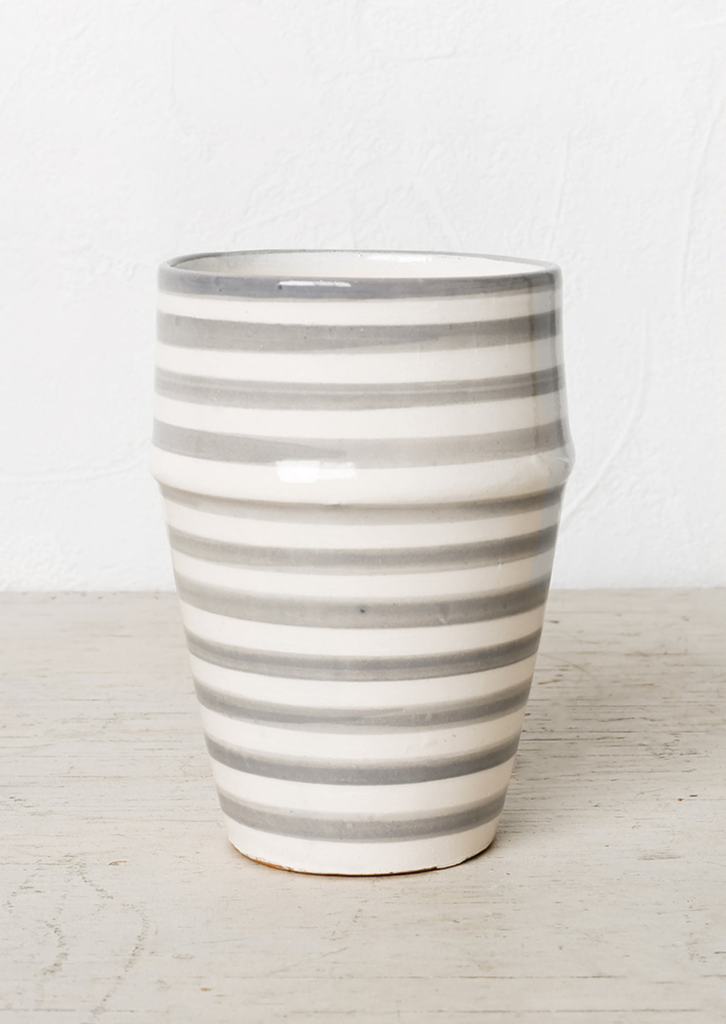Grey: A moroccan style ceramic cup in grey and white stripes.