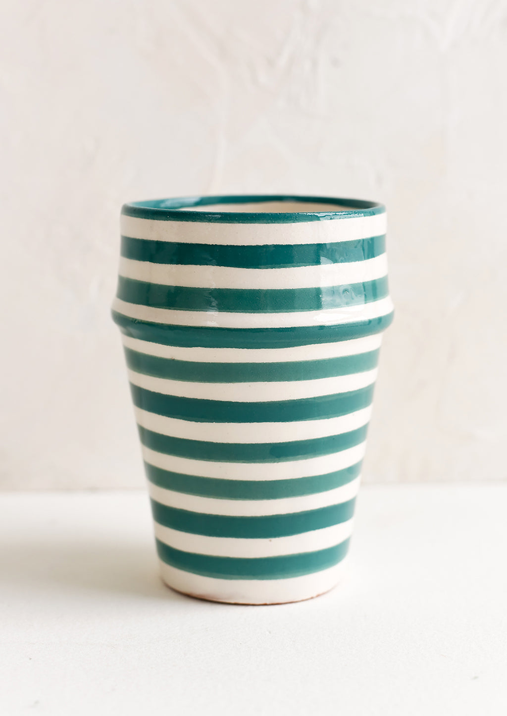 Teal: A moroccan style ceramic cup in teal and white stripes.