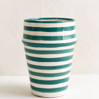 Teal: A moroccan style ceramic cup in teal and white stripes.