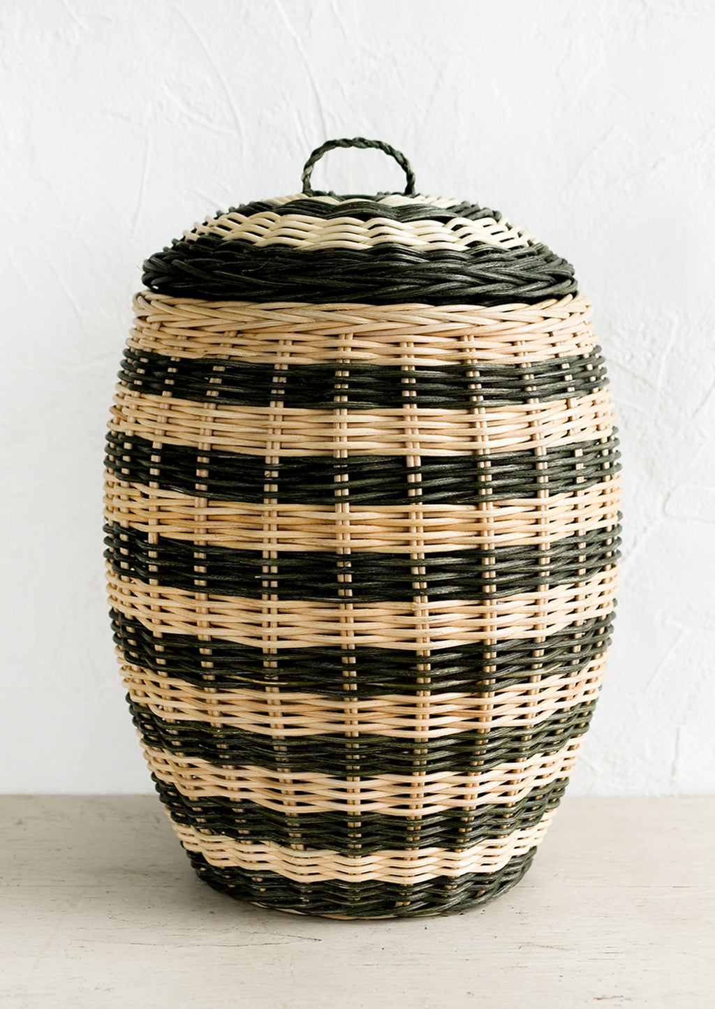 1: A tall hive shaped lidded basket in natural and dark green stripes.