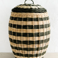 1: A tall hive shaped lidded basket in natural and dark green stripes.