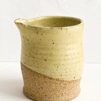Pastel Yellow: A small ceramic pitcher in dipped speckled yellow glaze.