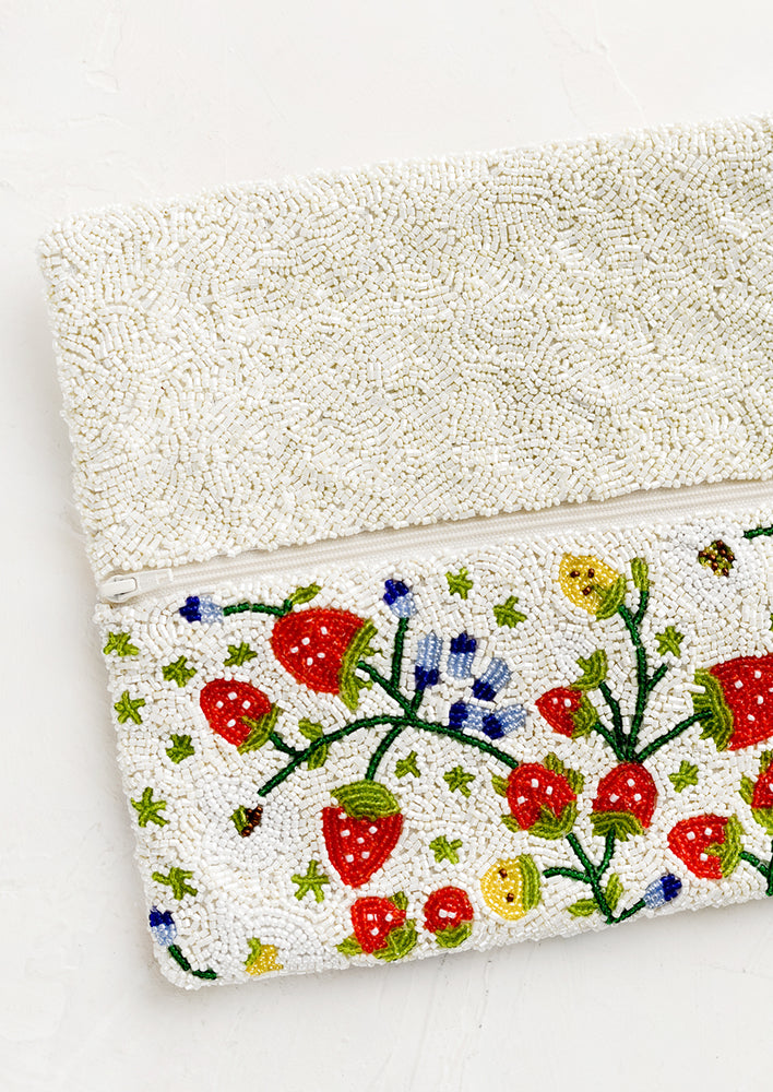 2: A rectangular foldover beaded clutch in white with multicolor strawberry pattern.
