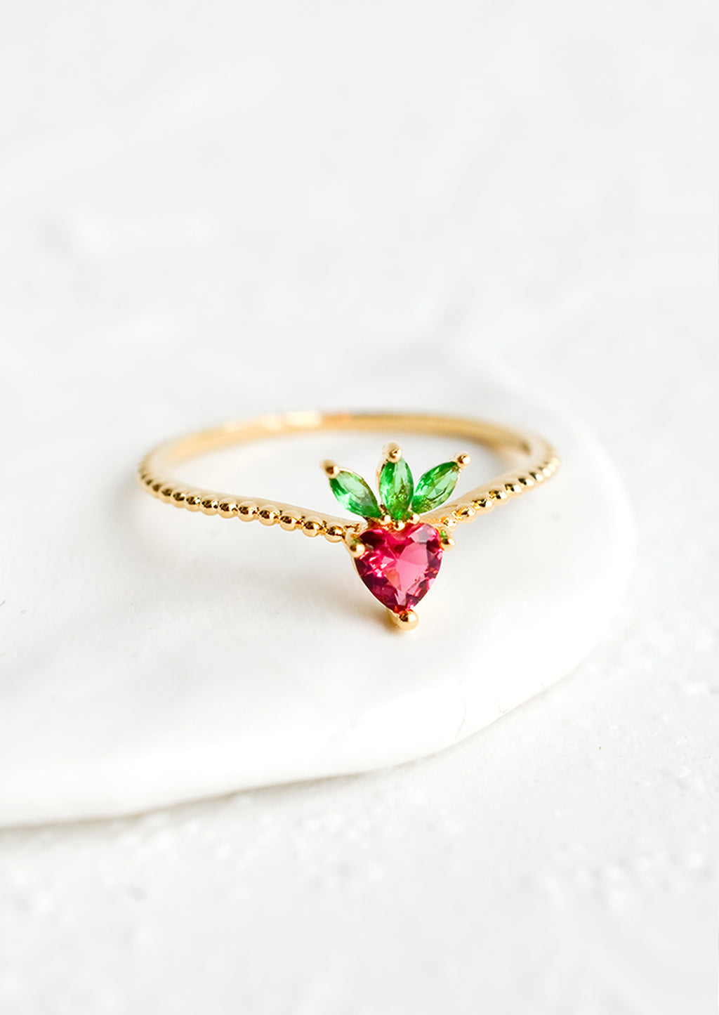 Strawberry / Size 5: A gold ring with beaded texture and strawberry shaped crystal front.