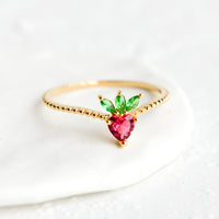 Strawberry / Size 5: A gold ring with beaded texture and strawberry shaped crystal front.