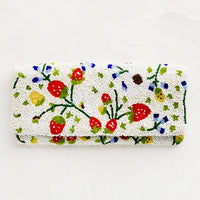 1: A rectangular foldover beaded clutch in white with multicolor strawberry pattern.