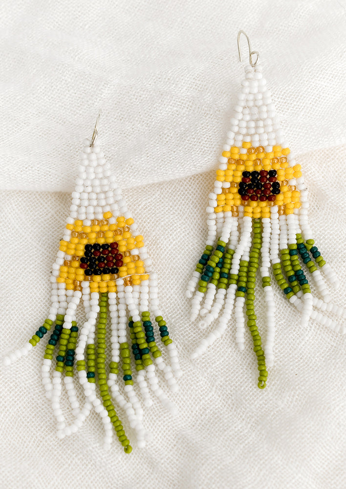 1: A pair of beaded fringe earrings with sunflower pattern.