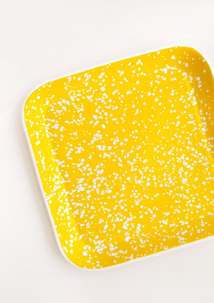 Square Enamel Tray in Yellow with Allover White Splatter Pattern and raised edges.