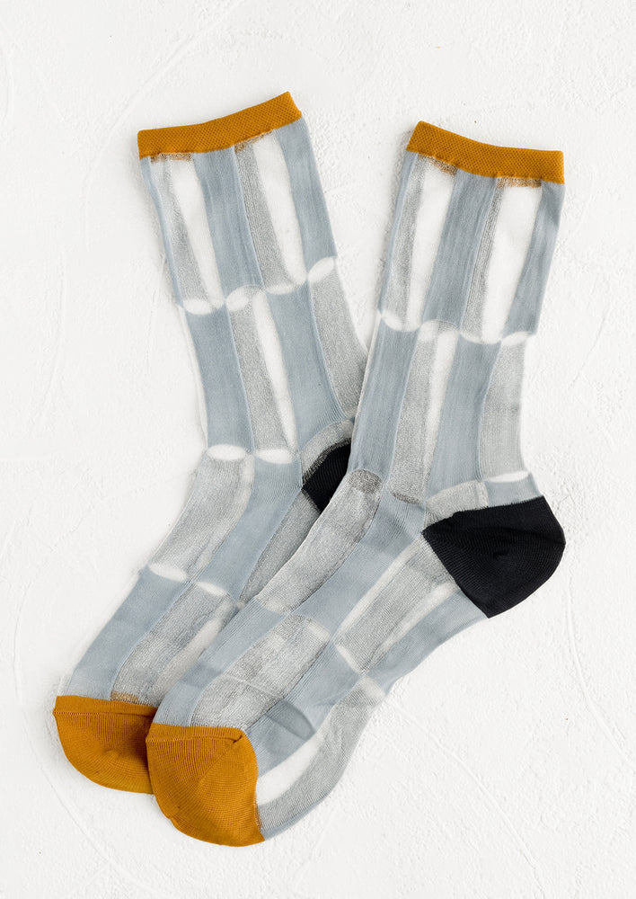 A pair of sheer nylon socks with blue-grey bar pattern and ochre trim.
