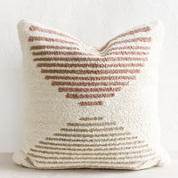 1: A tufted pillow in ivory with mauve and taupe geometric "horizon" design.