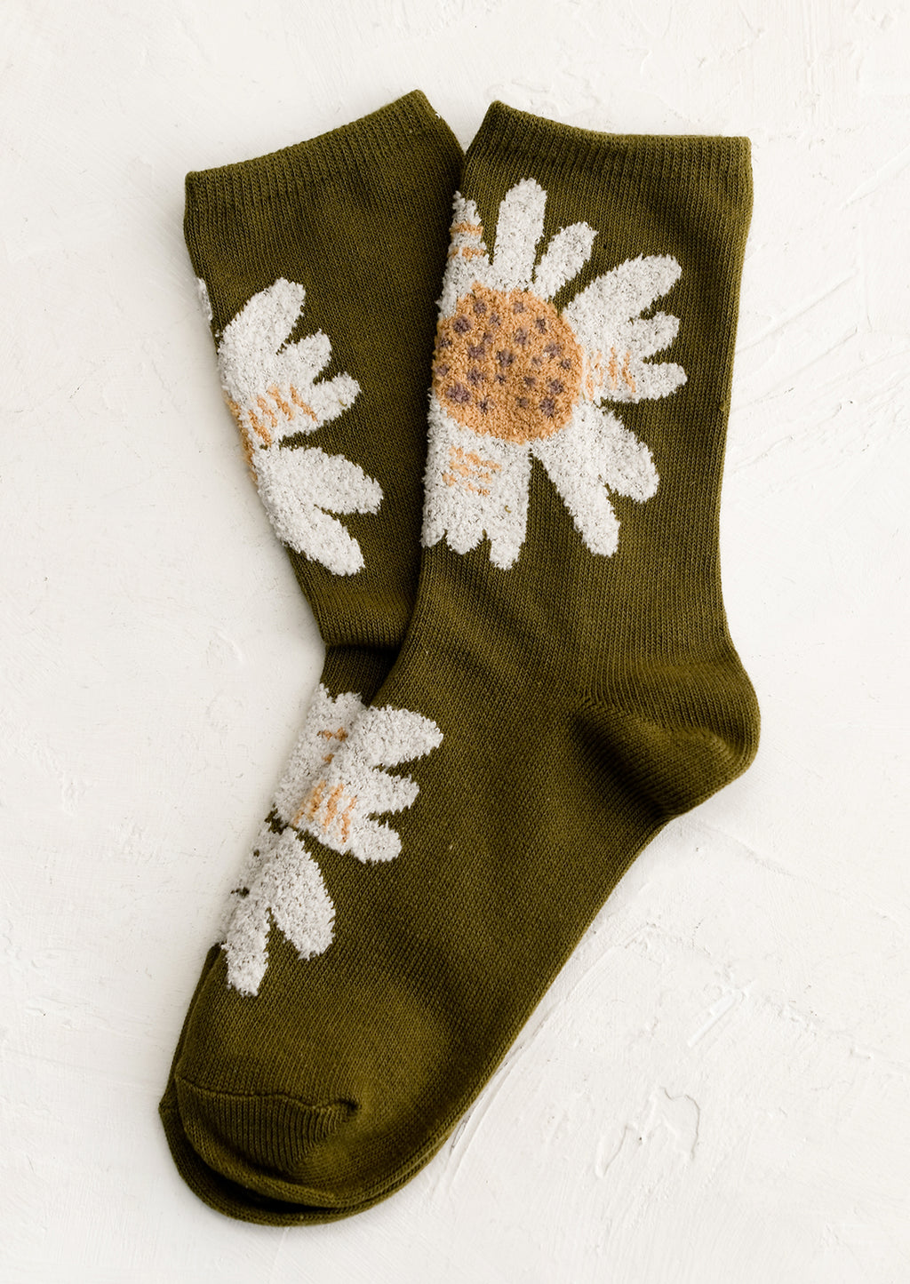 Olive: A pair of olive colored socks with fuzz textured, white-colored flowers.