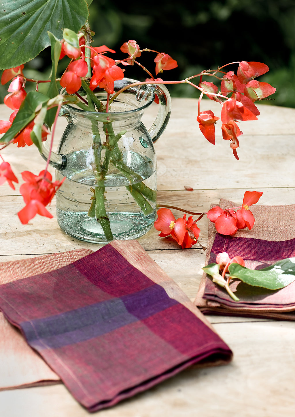 2: A pair of color overlay linen napkins on a table.
