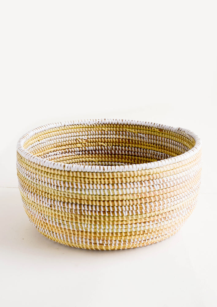 Woven storage basket made from grass with two-tone stripes made from recycled plastic