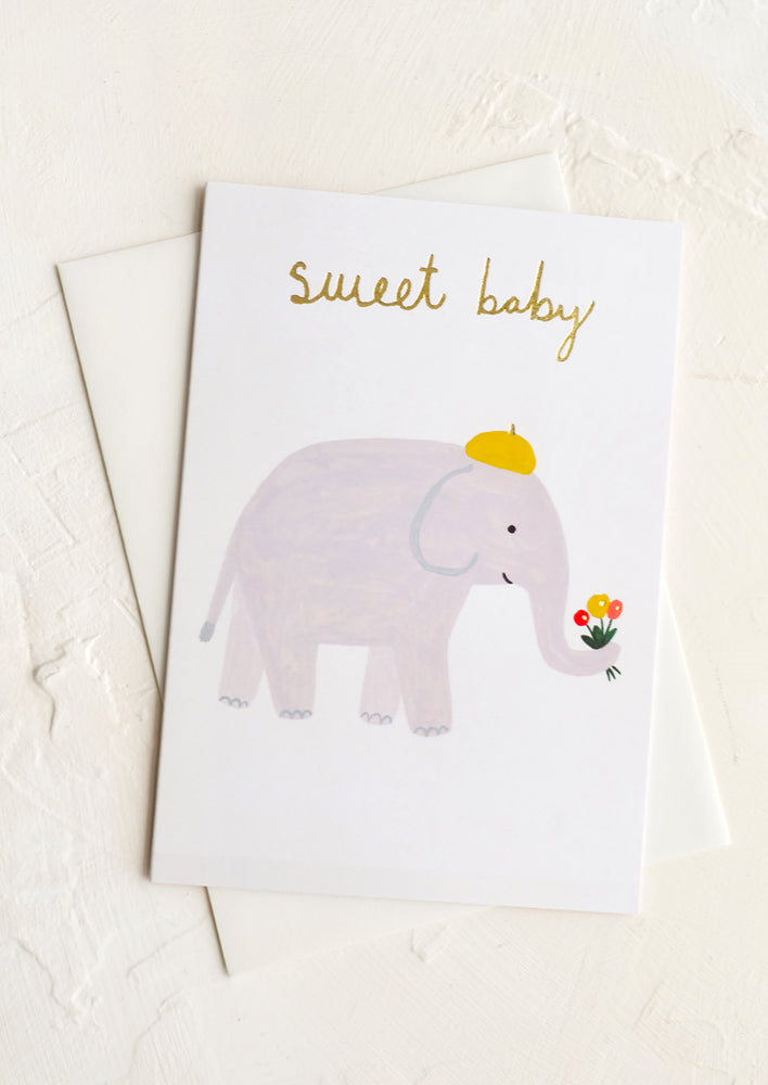 1: A greeting card with illustration of an elephant holding flowers in its trunk, text at top reads "sweet baby".
