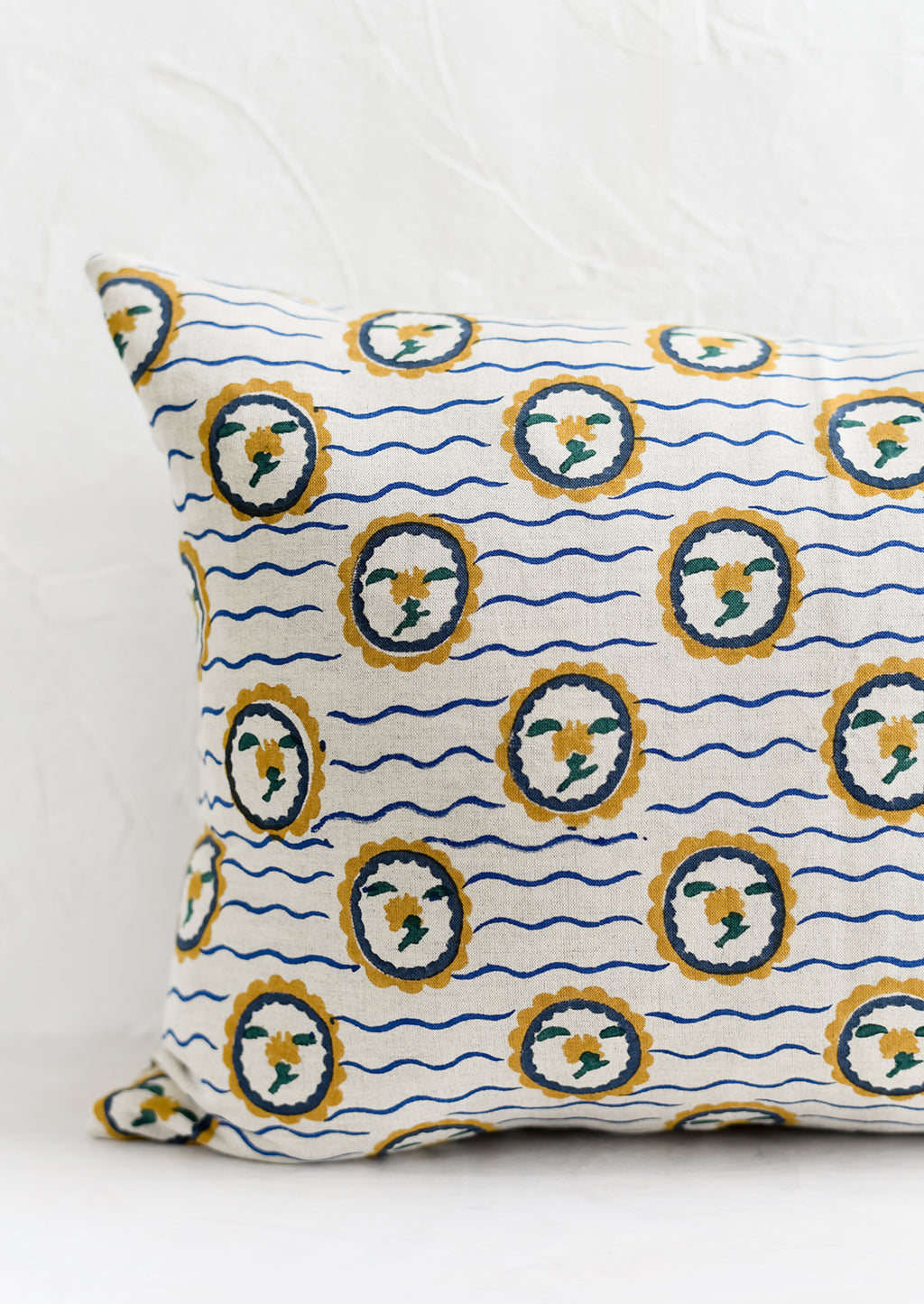 2: A block printed pillow with wavy floral motif.