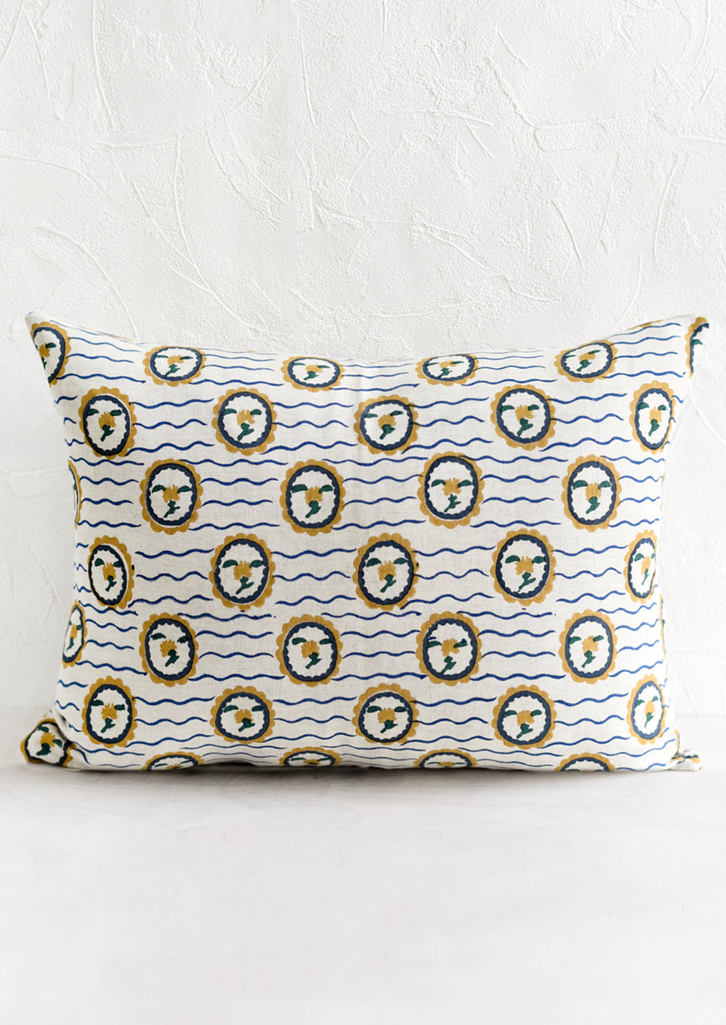 1: A block printed pillow with wavy floral motif.