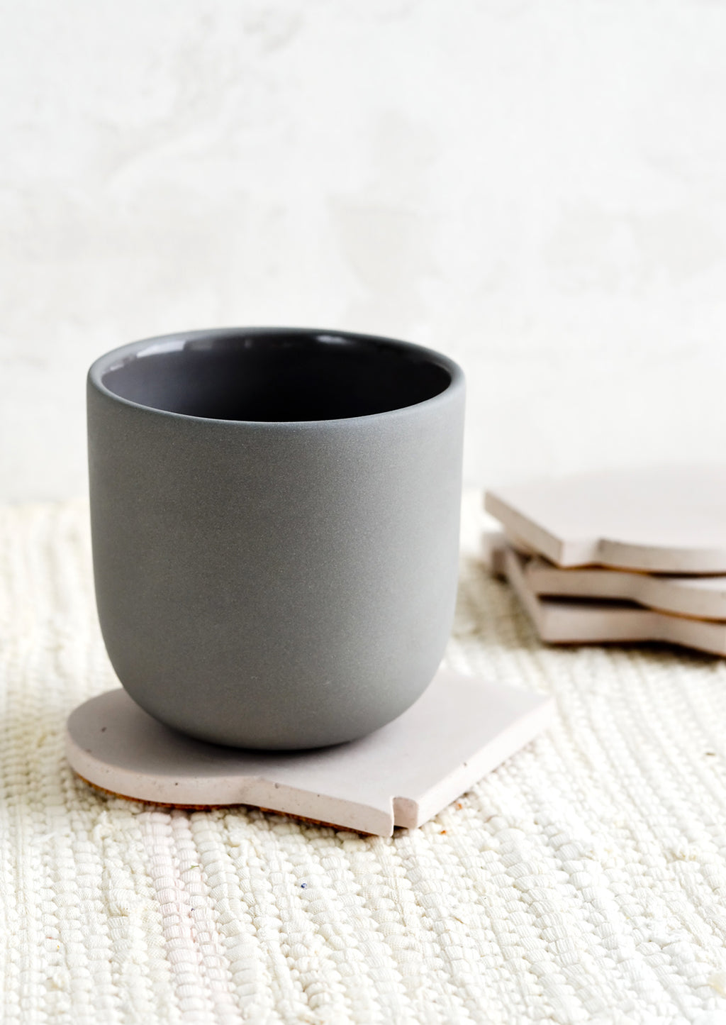 Pale Mauve: A ceramic cup on top of a coaster.