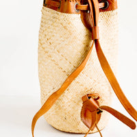 2: Tall and round woven straw bag with tanned leather backpack straps