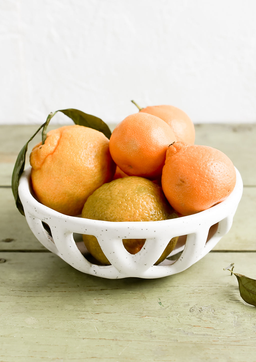 Small: A white ceramic fruit bowl with clementines.