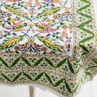 2: A block printed cotton tablecloth in vibrant green, pink and yellow floral pattern.