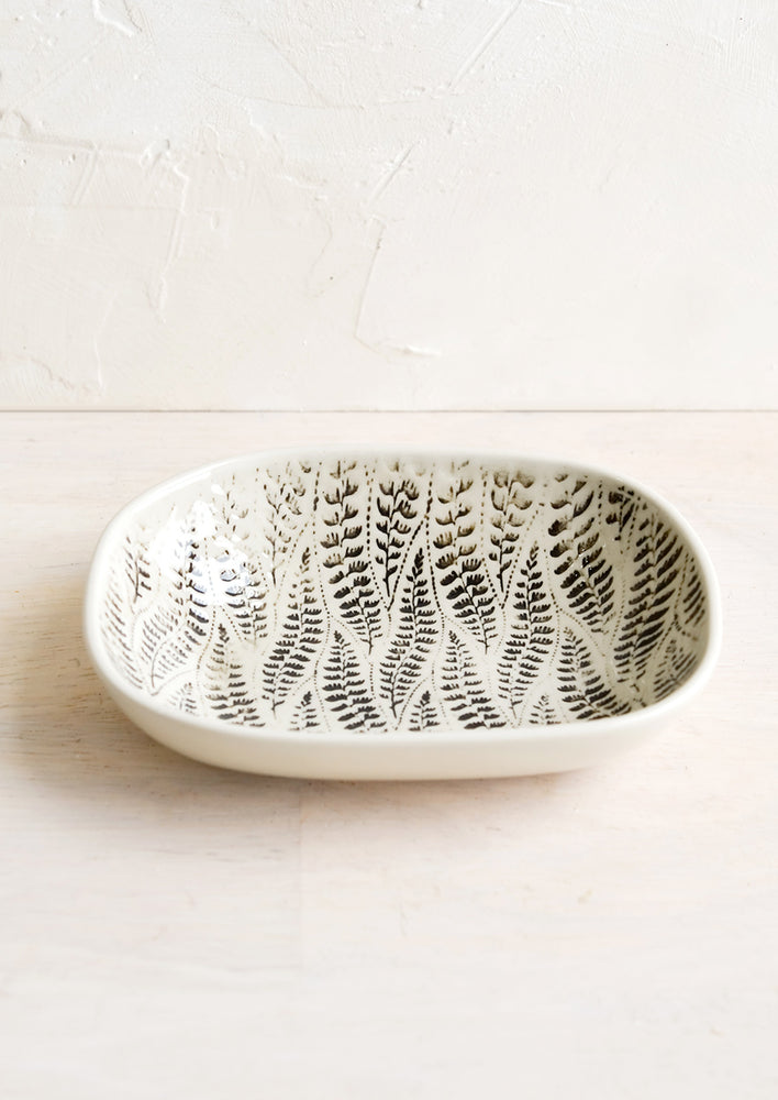 A small oval ceramic dish in leaf pattern.