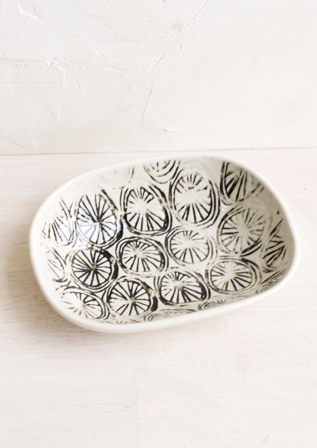 Pinwheel: A small oval ceramic dish in pinwheel pattern.