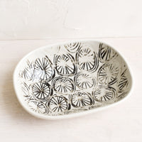 Pinwheel: A small oval ceramic dish in pinwheel pattern.