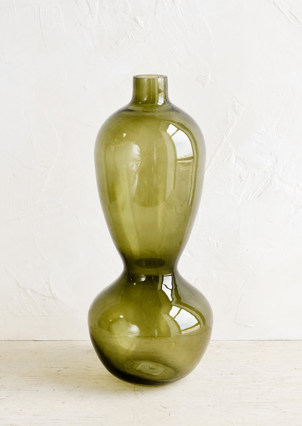 1: A tall glass vase in hourglass silhouette.