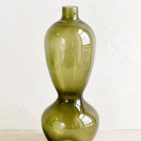 1: A tall glass vase in hourglass silhouette.