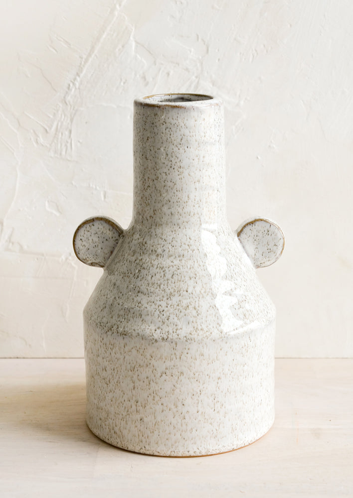1: A ceramic vase in glossy sand speckle glaze with round decorative tabs at sides.
