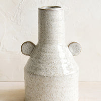 1: A ceramic vase in glossy sand speckle glaze with round decorative tabs at sides.
