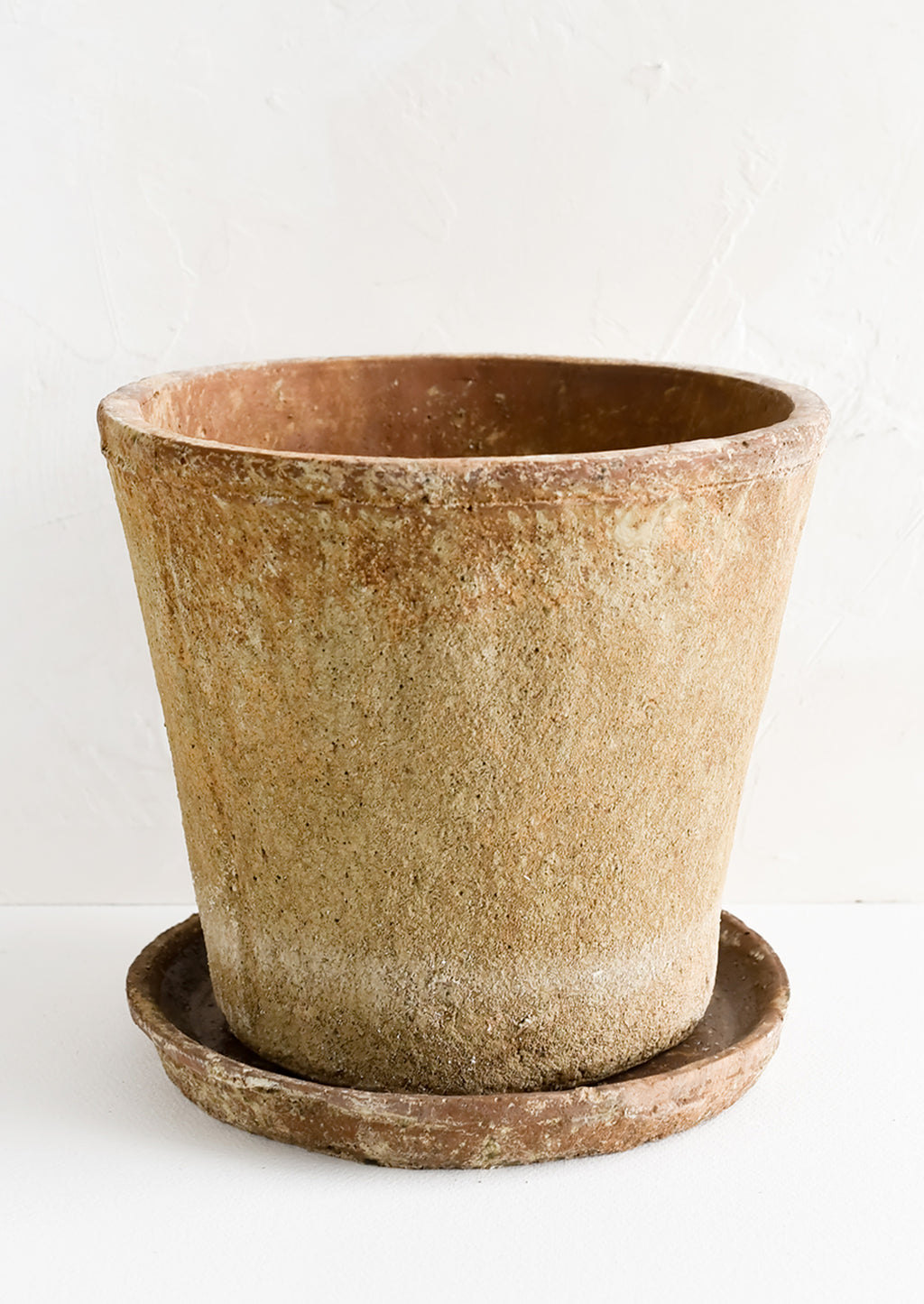 Large: A rustic, heavily textured terracotta clay planter with saucer.