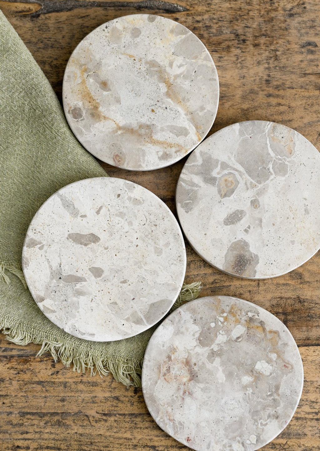 2: A set of round, beige marble coasters.