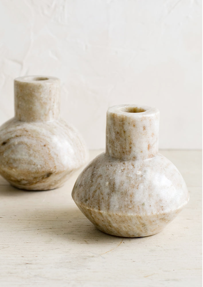 Taper candle holders in tan marble.
