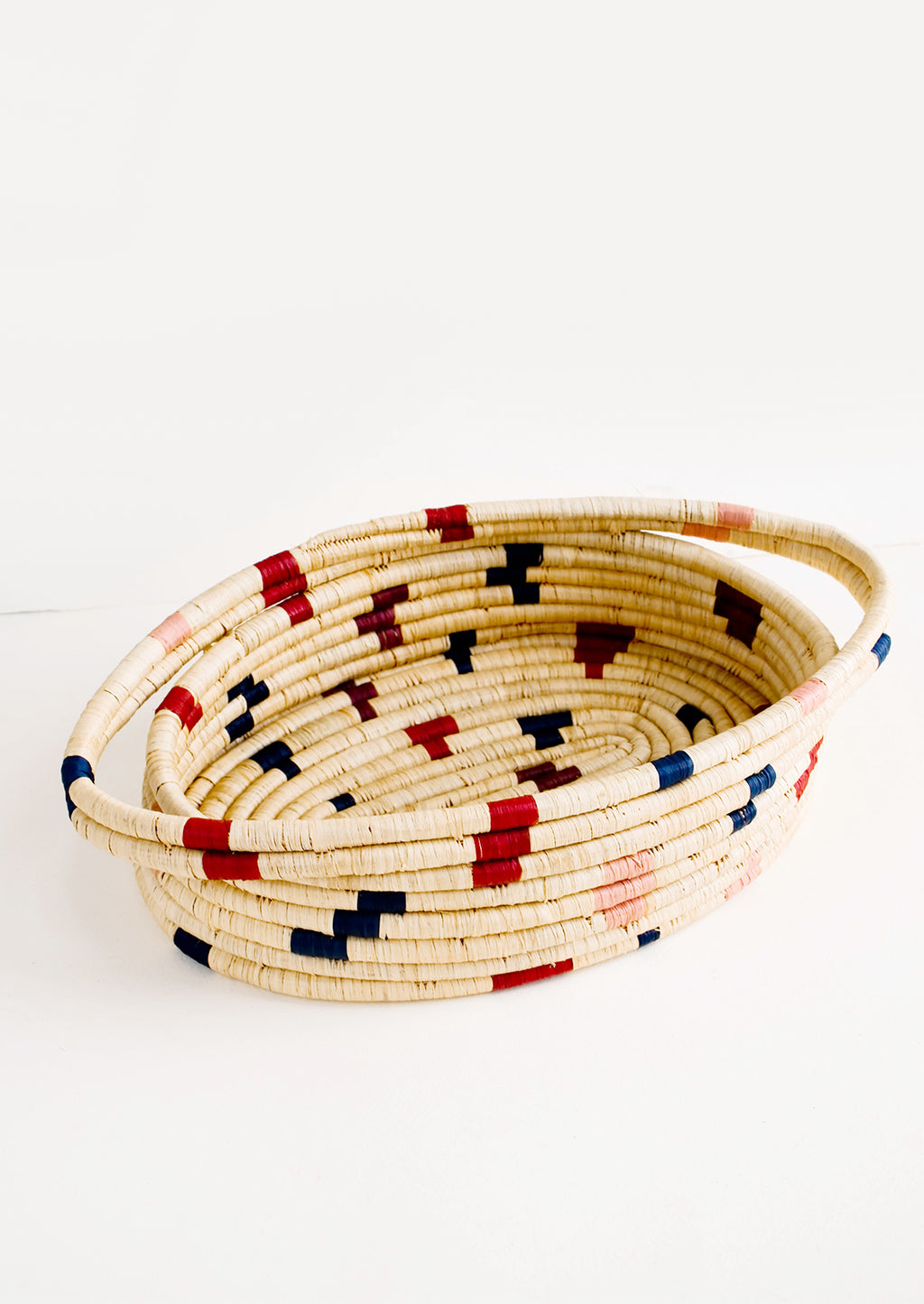 Berry Multi: Oval shaped, woven raffia basket with terrazzo inspired print in shades of wine