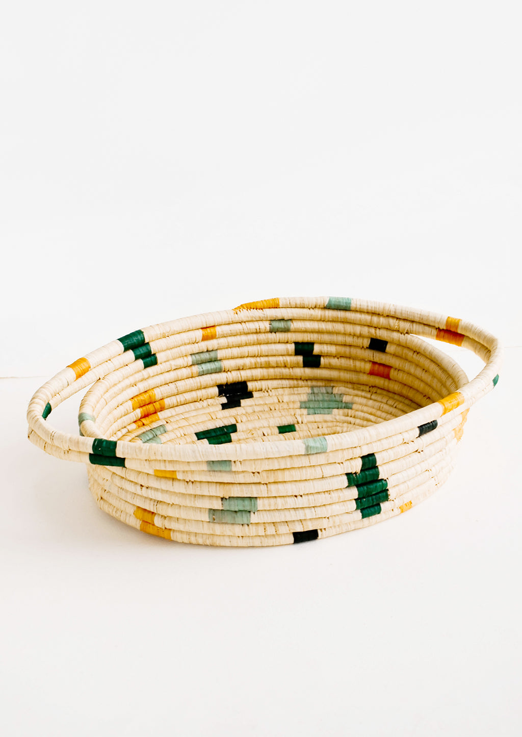 Forest Multi: Oval shaped, woven raffia basket with terrazzo inspired print in shades of green