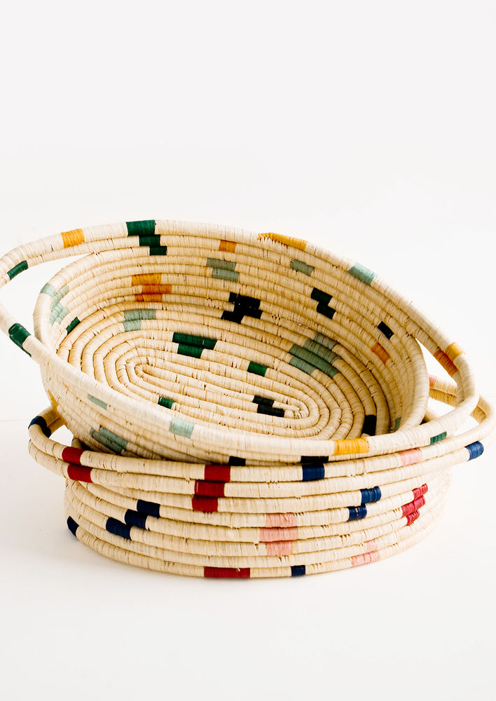 Oval shaped, woven raffia baskets with terrazzo inspired print