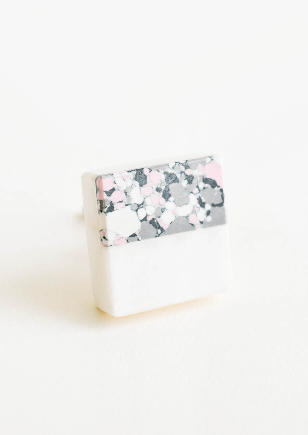 1: Square cabinet knob with white marble bottom half and splattered paint top half