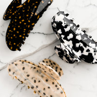 1: Terrazzo patterned hair claws in assorted colors.