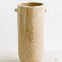 1: A tall, cylindrical ceramic vase in speckled brown glaze with decorative tab detailing at top.