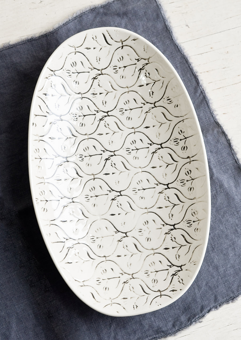 Small: A smaller oval shaped ceramic platter with black and white textile pattern.